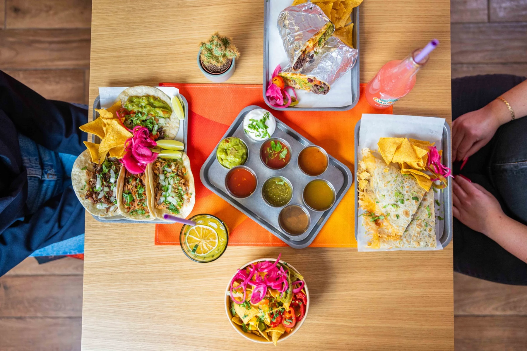 Papitos food spread with quesadilla, tacos and salsas